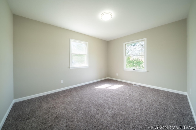 unfurnished room featuring baseboards, carpet, and visible vents
