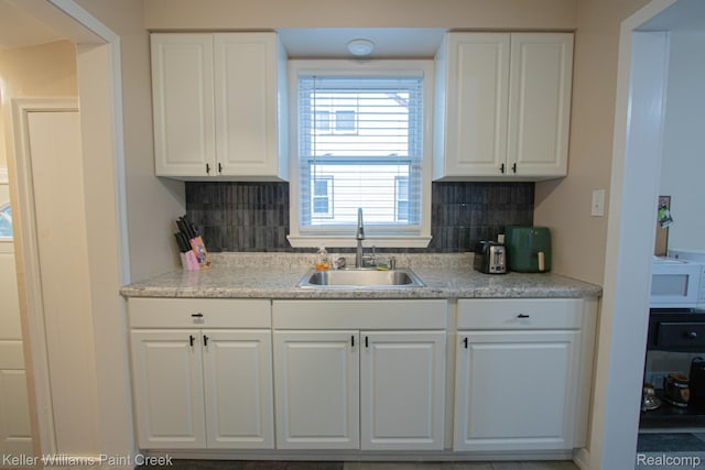 43 Canfield Dr, Mount Clemens, MI 48043 - kitchen with a sink, tasteful backsplash, and white cabinetry