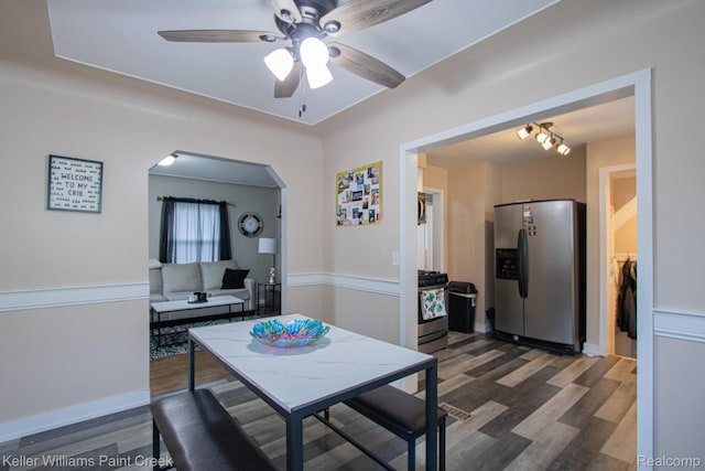 43 Canfield Dr, Mount Clemens, MI 48043 - dining area with arched walkways, ceiling fan, and dark wood-style flooring
