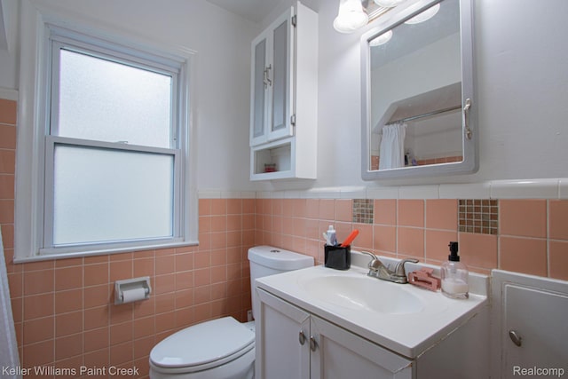 43 Canfield Dr, Mount Clemens, MI 48043 - full bathroom featuring tile walls, healthy amount of natural light, toilet, vanity, and wainscoting