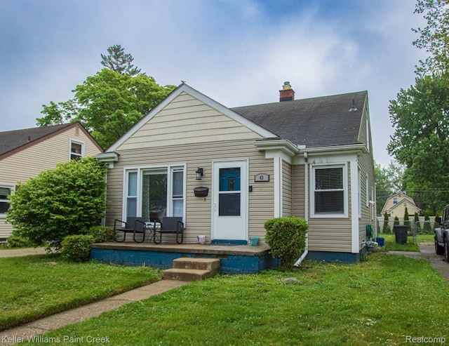 43 Canfield Dr, Mount Clemens, MI 48043 - view of front of home with a chimney, a porch, and roof with shingles