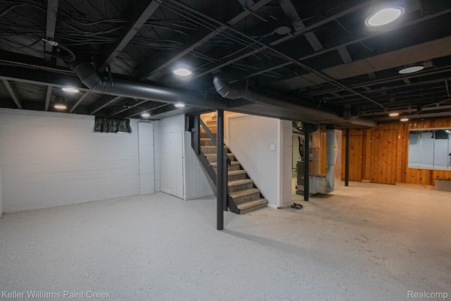 43 Canfield Dr, Mount Clemens, MI 48043 - finished below grade area featuring stairway, heating unit, concrete block wall, and wood walls
