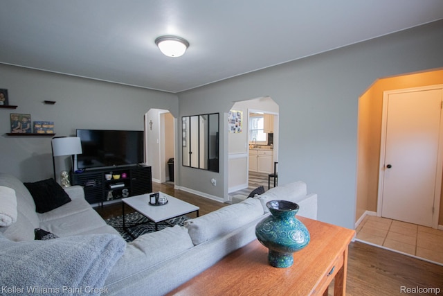 43 Canfield Dr, Mount Clemens, MI 48043 - living area featuring arched walkways, wood finished floors, and baseboards