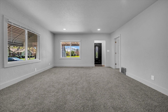 2061 E Whittemore Ave, Burton, MI 48529 - spare room featuring carpet floors, visible vents, baseboards, recessed lighting, and a textured ceiling