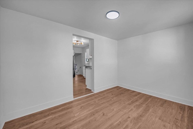 2061 E Whittemore Ave, Burton, MI 48529 - unfurnished room with light wood-style floors and baseboards