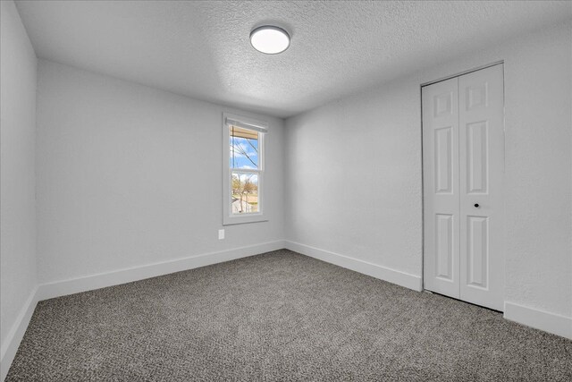 2061 E Whittemore Ave, Burton, MI 48529 - carpeted spare room featuring baseboards and a textured ceiling