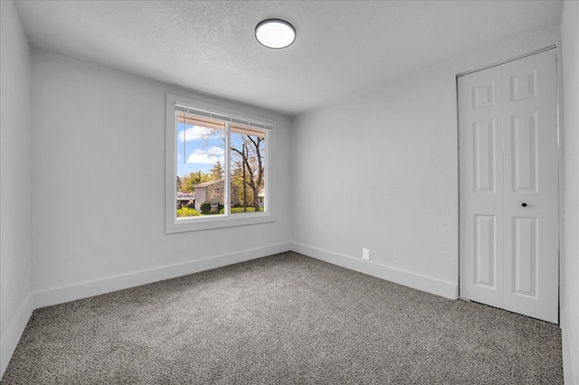 2061 E Whittemore Ave, Burton, MI 48529 - empty room featuring carpet floors, a textured ceiling, and baseboards