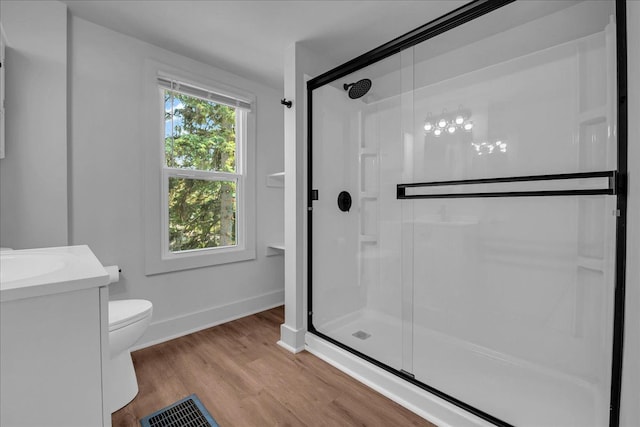 2061 E Whittemore Ave, Burton, MI 48529 - bathroom with visible vents, wood finished floors, toilet, baseboards, and a stall shower