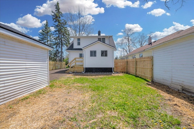 2061 E Whittemore Ave, Burton, MI 48529 - back of property with a lawn, fence, and a chimney