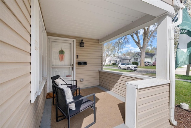 view of patio / terrace with a porch and a residential view