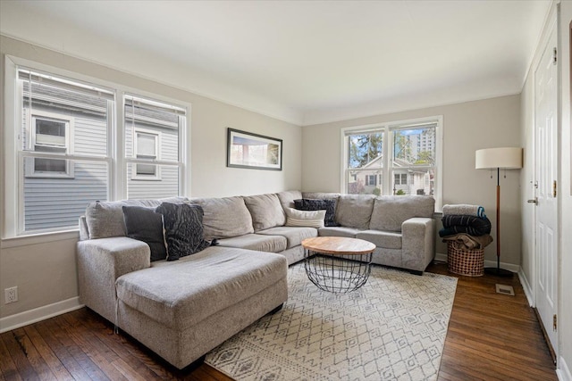 living area featuring baseboards, dark wood-style flooring, and visible vents