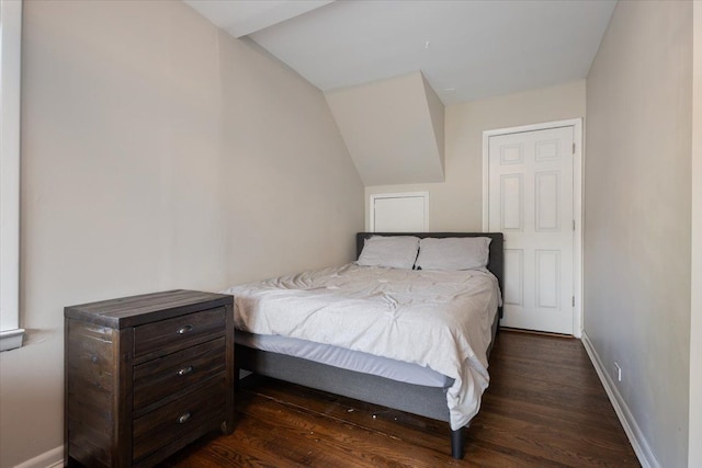 bedroom featuring baseboards and dark wood-type flooring