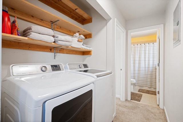 washroom featuring baseboards, light carpet, laundry area, and washer and dryer