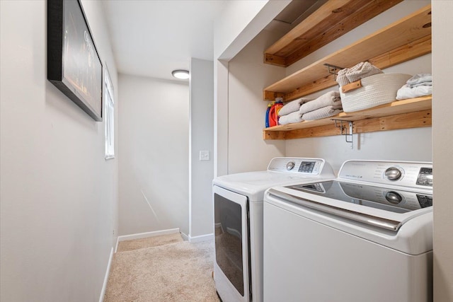 washroom featuring baseboards, laundry area, light colored carpet, and washer and clothes dryer