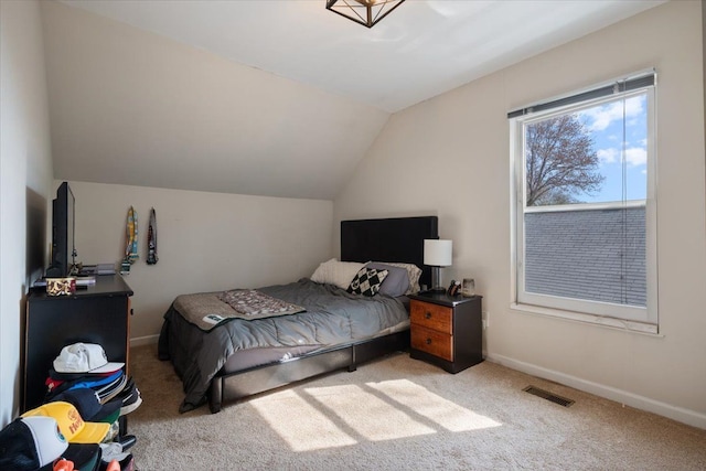 bedroom with baseboards, carpet flooring, lofted ceiling, and visible vents