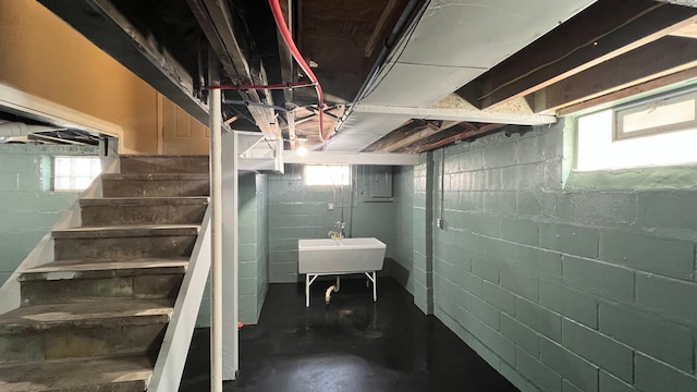 below grade area featuring a sink and stairs
