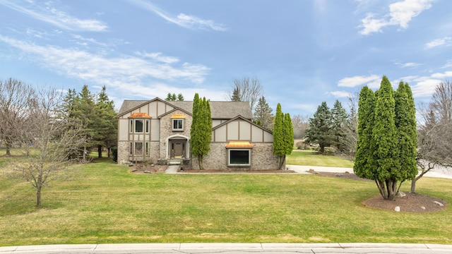 tudor home with stone siding, stucco siding, and a front yard