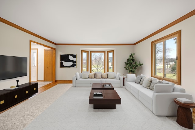 living room with crown molding, baseboards, and light colored carpet
