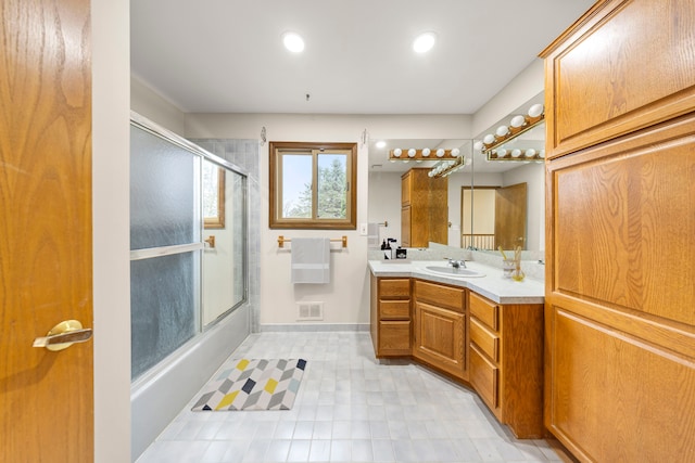 full bath with vanity, enclosed tub / shower combo, recessed lighting, baseboards, and visible vents