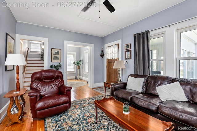 879 Lawrence St, Detroit, MI 48202 - living area with wood finished floors, a ceiling fan, and stairs