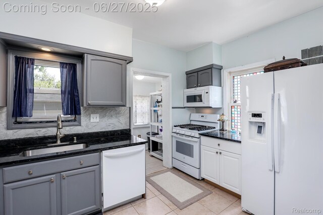 879 Lawrence St, Detroit, MI 48202 - kitchen with white appliances, gray cabinets, light tile patterned floors, and dark stone countertops