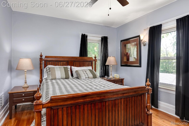 879 Lawrence St, Detroit, MI 48202 - bedroom with wood finished floors, multiple windows, and ceiling fan