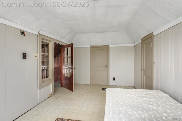 879 Lawrence St, Detroit, MI 48202 - bedroom featuring lofted ceiling, light flooring, and a textured ceiling