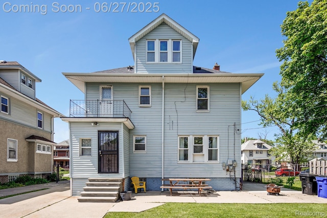 879 Lawrence St, Detroit, MI 48202 - back of property featuring a balcony, an outdoor fire pit, and a chimney
