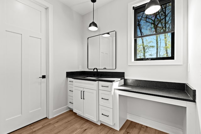 bathroom with wood finished floors and vanity