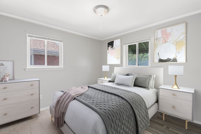 bedroom with baseboards, ornamental molding, and multiple windows