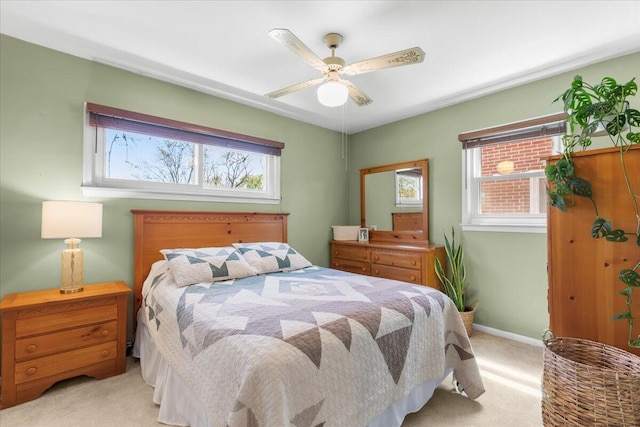 bedroom featuring baseboards, a ceiling fan, and light colored carpet