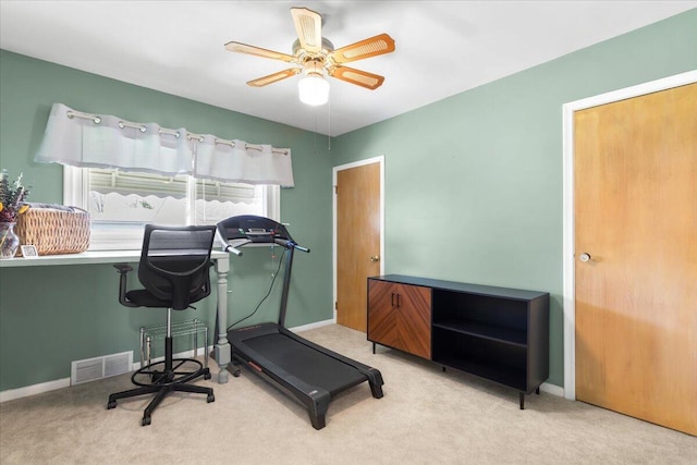 exercise room featuring carpet floors, baseboards, ceiling fan, and visible vents