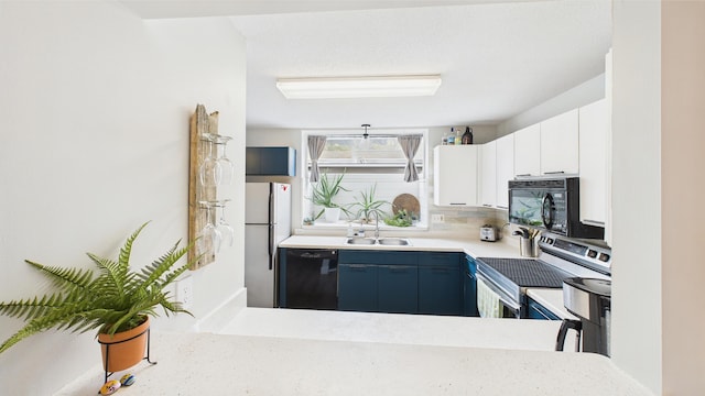 kitchen featuring blue cabinetry, a sink, light countertops, white cabinets, and black appliances