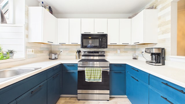 kitchen featuring blue cabinets, electric range, black microwave, tasteful backsplash, and light countertops