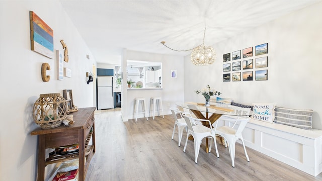 dining space with an inviting chandelier and wood finished floors