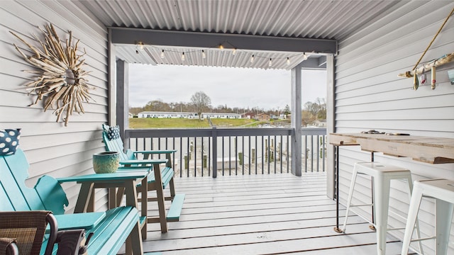 wooden terrace featuring covered porch
