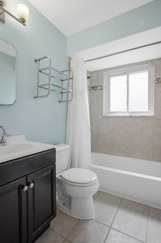 bathroom with vanity, tile patterned flooring, shower / bath combo with shower curtain, and toilet