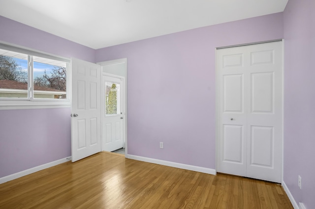 interior space featuring baseboards and wood finished floors