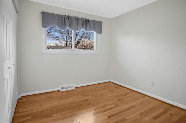 unfurnished bedroom with light wood-style floors, baseboards, a closet, and visible vents