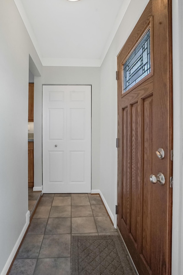 tiled foyer featuring baseboards