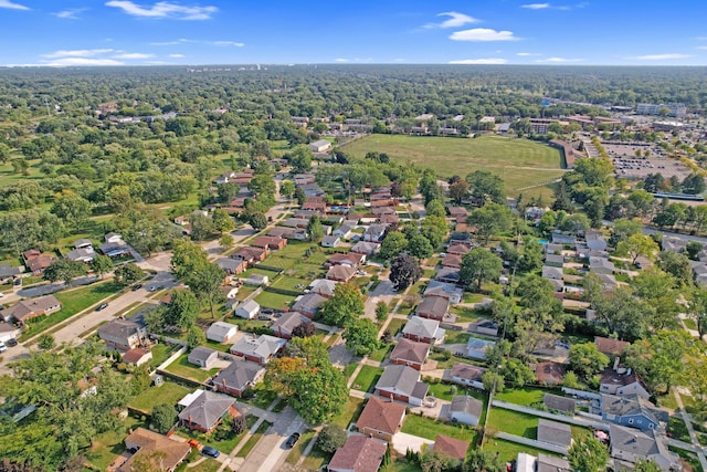 birds eye view of property featuring a residential view and a wooded view