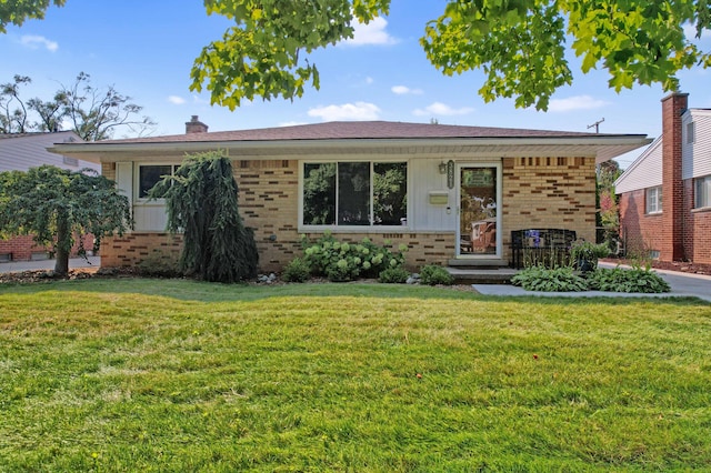 ranch-style home with board and batten siding, a chimney, a front lawn, and brick siding
