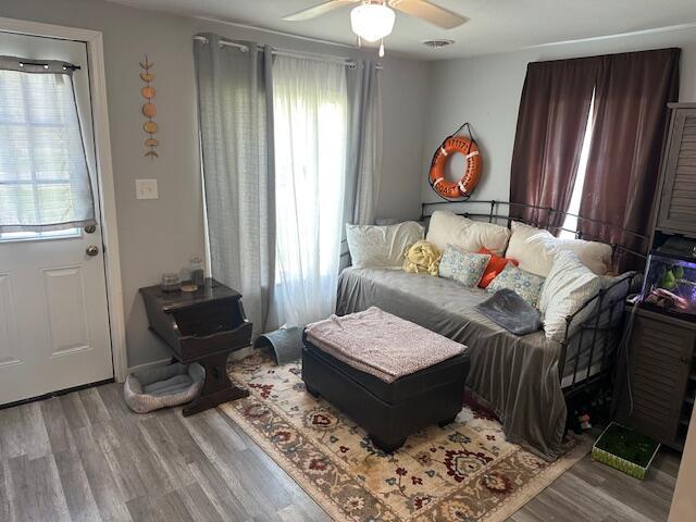 bedroom with ceiling fan and wood finished floors