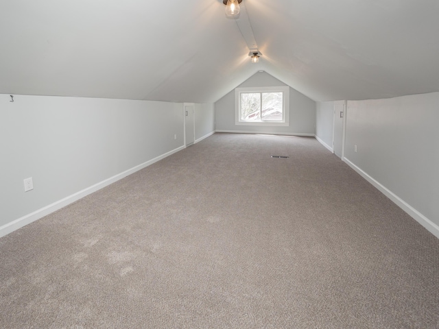 bonus room with baseboards, carpet floors, and lofted ceiling