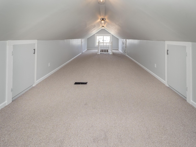 bonus room with visible vents, baseboards, lofted ceiling, and carpet