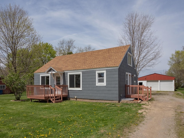 back of property featuring dirt driveway, an outbuilding, a wooden deck, a detached garage, and a shingled roof