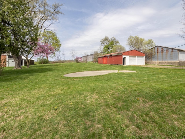 view of yard with an outbuilding and a garage