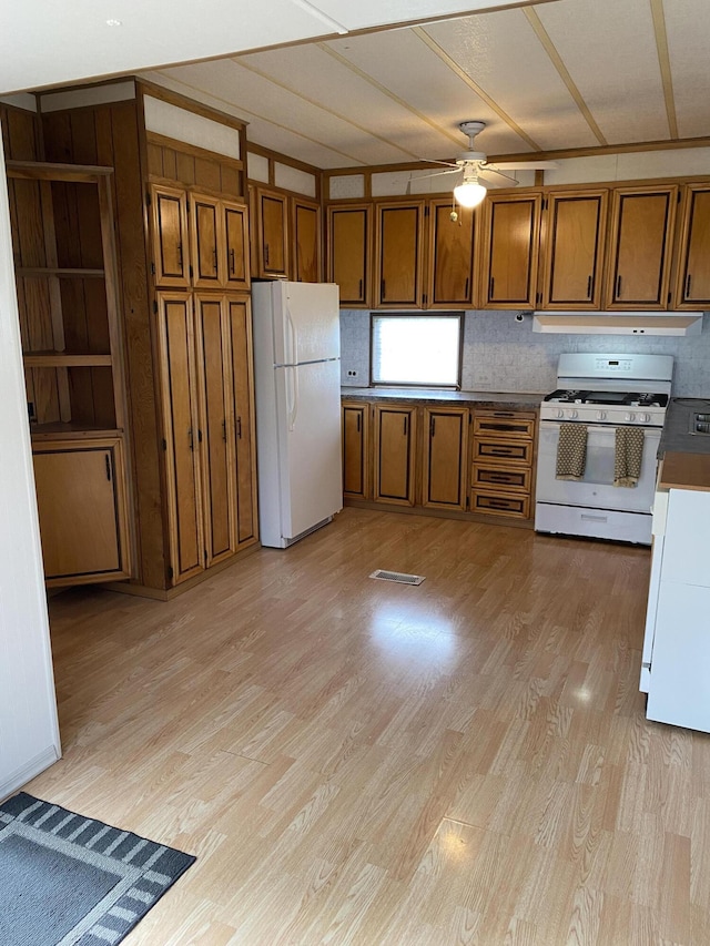 kitchen featuring white appliances, a ceiling fan, brown cabinetry, and light wood-style floors