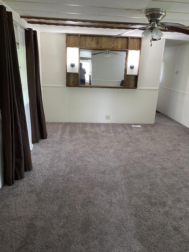 unfurnished living room with carpet flooring and a ceiling fan