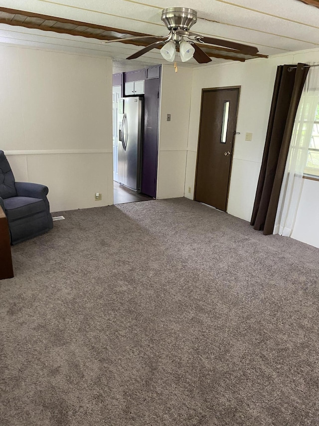 unfurnished living room with ceiling fan and carpet flooring